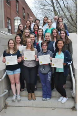 students and faculty posing with certificates alongside one another