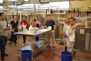 Creamery manager Bill Sciturro demonstrates the ice cream making process to students