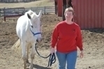 Dr. Jenifer Nadeau posing alongside horse