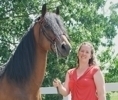 Dr. Sarah Reed posing alongside horse